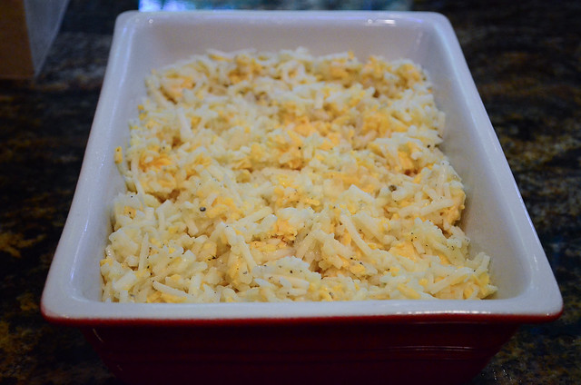 The hash brown mixture is transferred to a casserole dish.