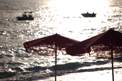 sunset red sea summer vacation two sun sunlight seascape color reflection travelling beach water silhouette horizontal umbrella outdoors island boat focus quiet bokeh wave nopeople depthoffield greece shore serene transparent kefalonia cephalonia lourdata