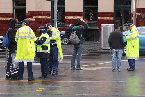 Police book jaywalkers outside Flinders Street Station