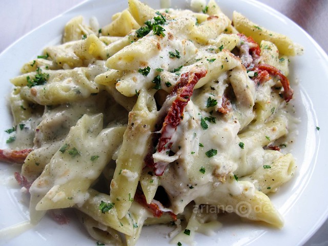 Club Ilia's baked chicken penne with sun-dried tomato, basil, parsley, Alfredo sauce