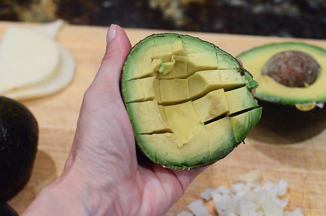 A half of avocado that has been sliced into sections.