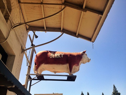 signs rooftop animal sign statue rural landscape countryside town store market farm beef label painted scenic bull meat lookup business butcher snack storefront beast perched hungry roadside steer herd attraction jerky watchful whatsinstore