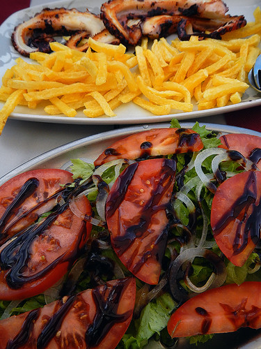 Having a lunch of pulpo, mussels, salad and fries at a seaside café on Spain's Galician coast