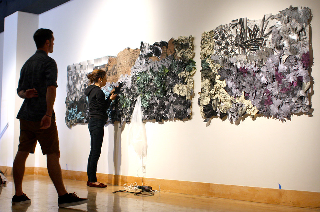 Nyssa Zinn installs her collage panoramic piece for the Masters of Fine Arts Thesis Exhibition at the Fine Arts Gallery on campus, Friday, April 12, 2013. Photo by Gabriella Gamboa / Xpress