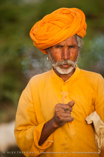 old portrait orange india male men yellow standing beard asian outside outdoors asia sitting adult emotion cigarette indian religion earring pride smoking moustache growth mugshot characters facialhair farmer copyspace turban wisdom oriental browneyes relaxation sideview staring hindu hinduism curiosity adultsonly oneperson rajasthan oldfashioned stubble headdress traditionalculture headwear headandshoulders whitehair greyhair facialexpression brightcolour rajasthani handlebarmoustache senioradult seniorman traditionalclothing realpeople humanhead humanface traveldestinations lookingatcamera blankexpression onlymen thehumanbody onemanonly matureadult indiansubcontinent plainbackground seniormen orangeturban traditionallyindian 4549years