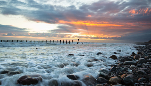 sunset sea water clouds rocks groynes walney
