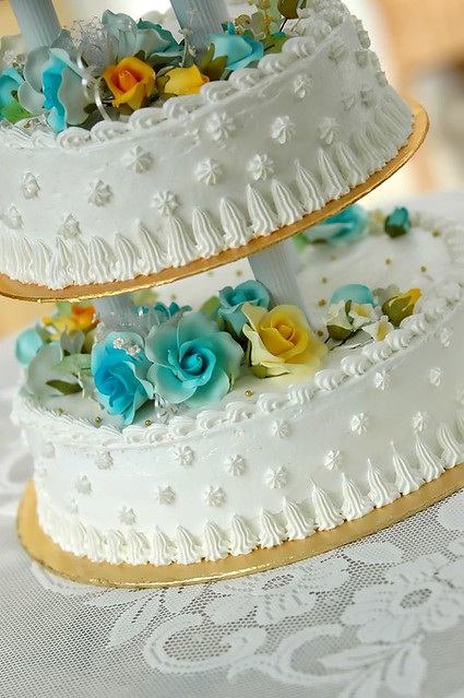 Gorgeous wedding cake with yellow and blue flowers by Cake Decorating Videos