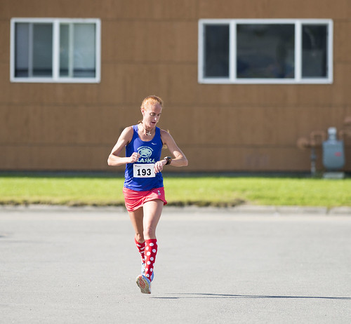 Michelle Mitchell checks her time in the final yards of the race. She was the women's winner and second place overall.