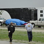 Two team members brave the elements to purchase their pit passes on Friday