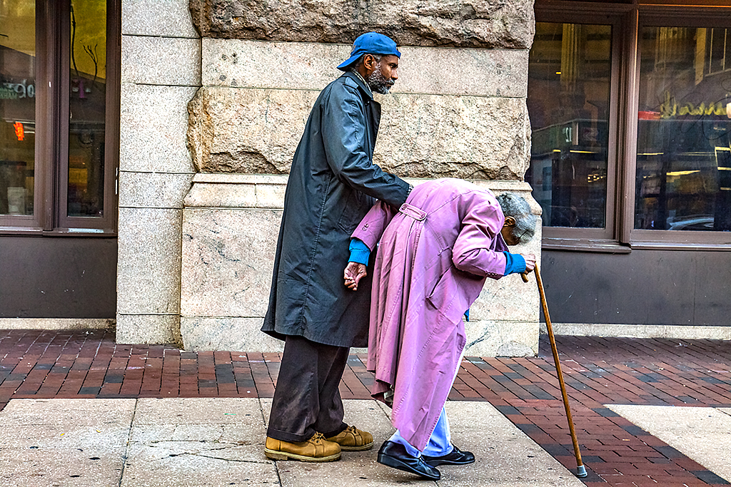 Man helping old woman to walk--Center-City