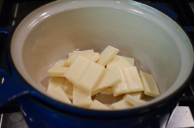 Slices of white chocolate are added into the double boiler.