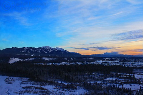 city blue trees winter sky mountain snow cold green yellow clouds buildings landscape lights town pretty frost hills valley whitehorse yukonriver greymountain canoneos7d adobephotoshopelements9