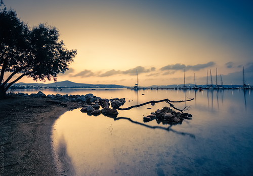 longexposure blue sky tree water yellow clouds sunrise canon landscape boats gold dawn rocks published greece cyclades milos waterscape canonefs1022mmf3545usm adamantas canoneos40d
