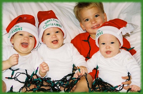 Triplets in Santa hats with Big Brother