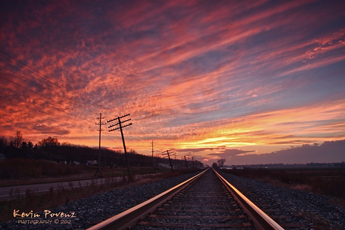 railroad pink november blue sunset sun reflection yellow clouds evening kevin track telephonepoles 2012 nationalgeographic povenz