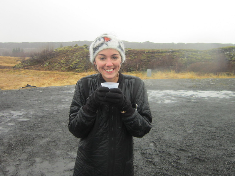 Flora sipping hot chocolate after snorkeling Silfra Rift, Iceland