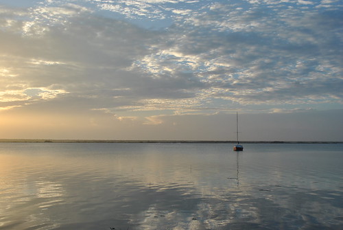 blue orange sun lake water clouds sunrise reflections boat yucatan wetlands peninsula quintanaroo bacalar