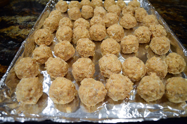 The Rice Krispie mixture is formed into balls are arranged on a foil line baking sheet.