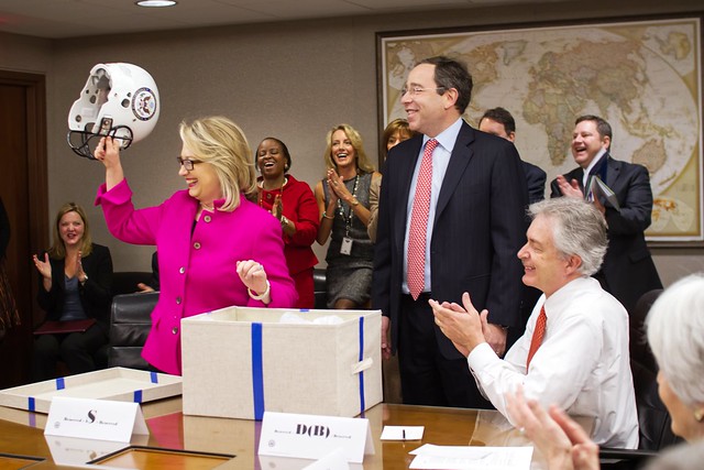 Secretary Clinton Is Presented With a Football Helmet
