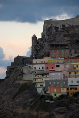 Austere castle and church, colourful houses