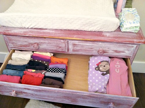 organizing baby clothes in drawers
