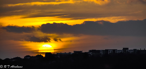 sunset orange yellow clouds shadows rooftops plymouth
