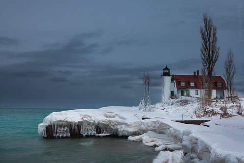 trees winter lighthouse lake seascape ice water landscape outdoors pier waves michigan lakemichigan shore beacon icles