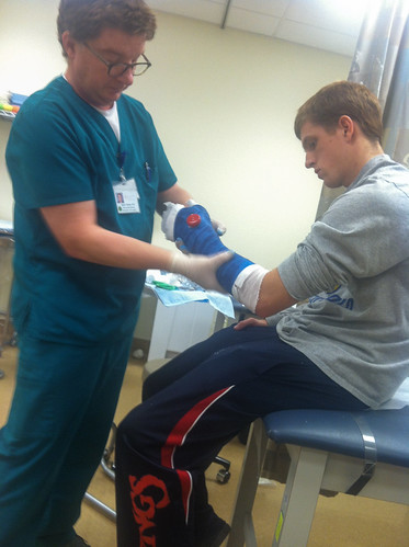 A doctor applying a cast to boy#4.