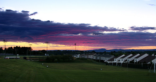 sky sunset purple blue red orange clouds outdoors outside houses highschool field