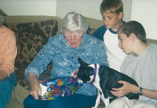Heidi watches Grandma open a present.