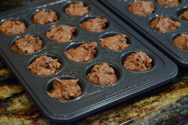 The batter is divided between two mini muffin pans.