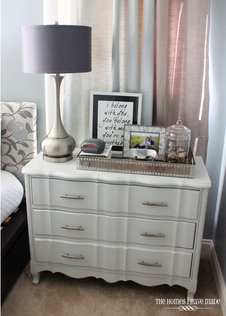 A dresser styled with modern decor in a master bedroom