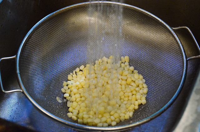 Frozen corn thawing out in the water.