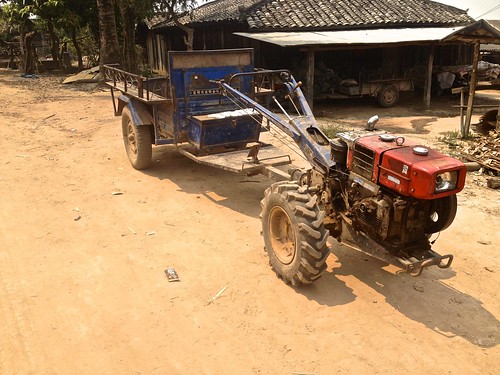 just like in Burma, these engines strapped to two wheels were fairly popular in rural Laos and were often towing a cart with another two wheels