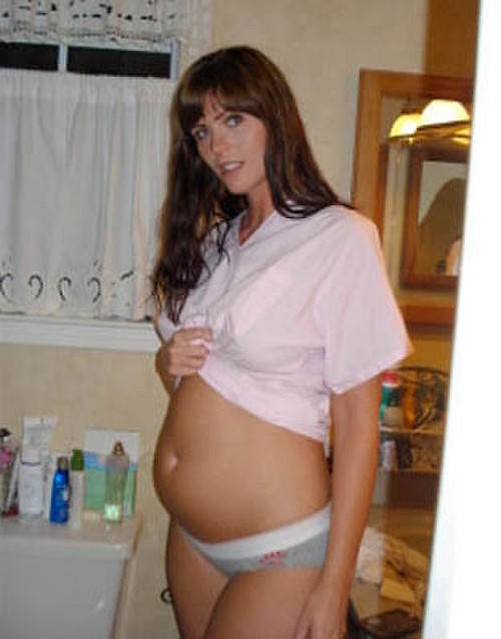 Woman growing a big belly in bikini