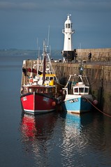 Boats moored by Mevagissey lighthouse