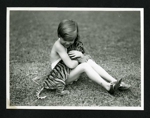 Unidentified child with tiger cub photographed during the the National Geographic Society-Smithsonian Institution Expedition to the Dutch East Indies, 1937