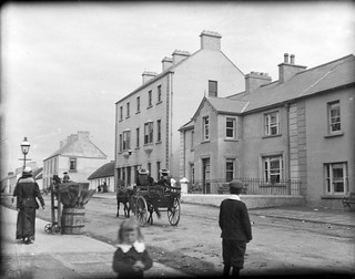 Street in a village, with horse and cart, and bystanders = Main Street, Bundoran