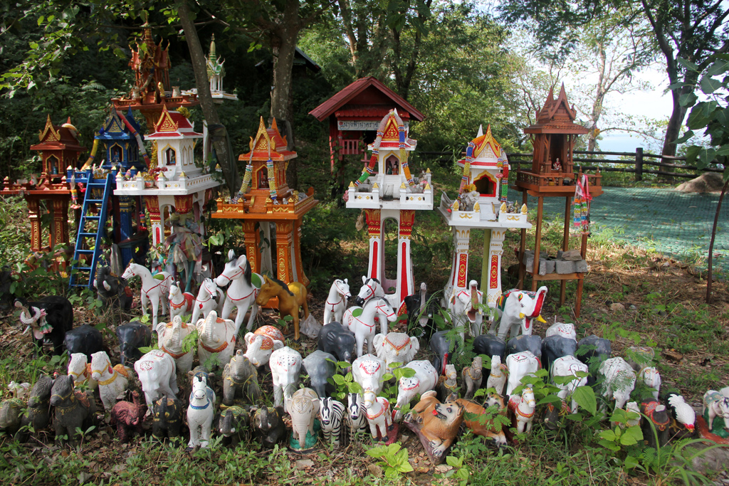 Spirit house teeming with statue animals