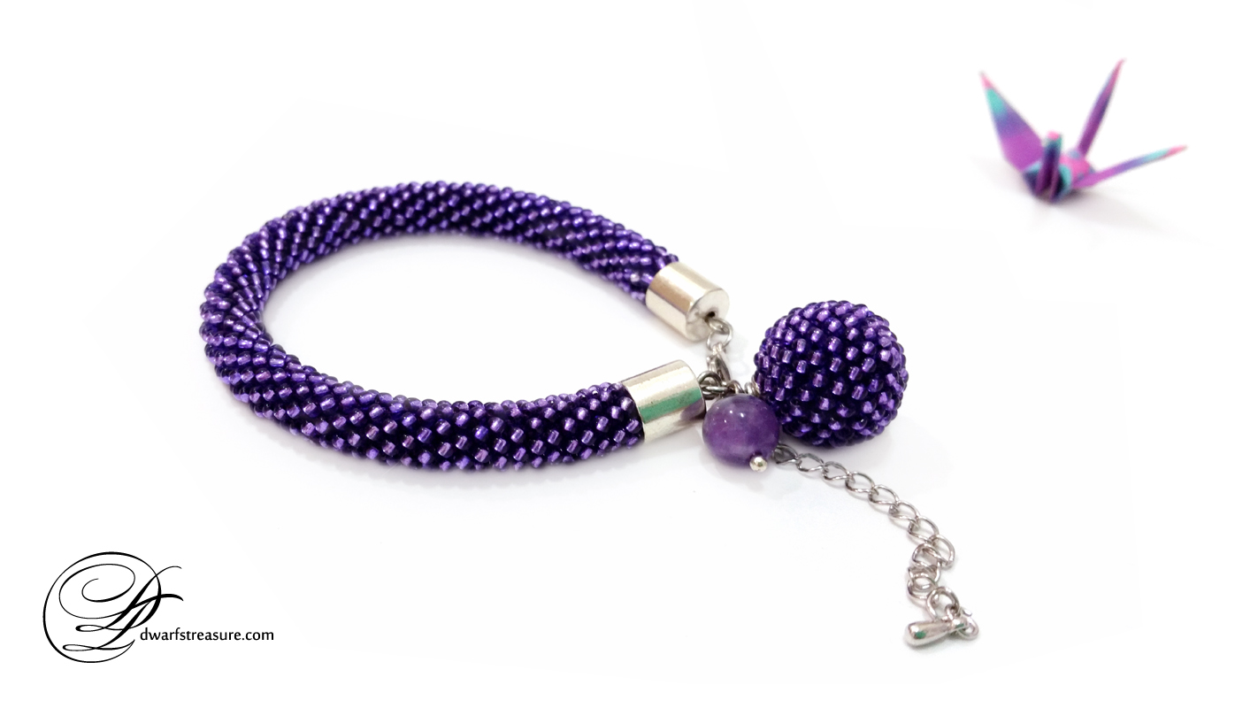 Ornate ultraviolet custom made beaded crochet bracelet with origami crane