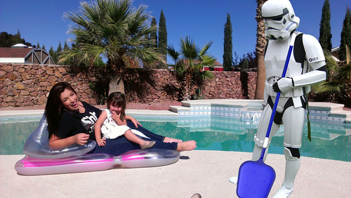 A storm trooper in full costume including leggings (not just the mask!) cleaning a pool. We must see someone lounging in a swimsuit holding a cocktail nearby