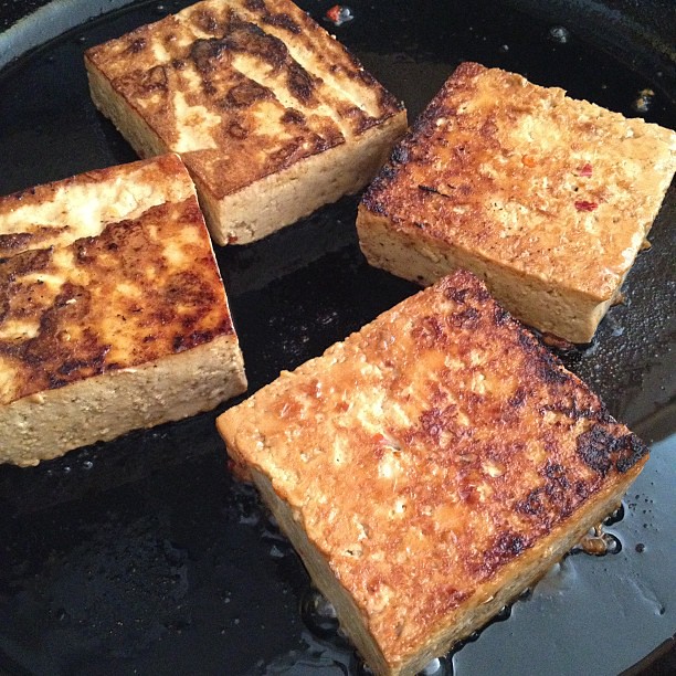 Frying up some marinated tofu.