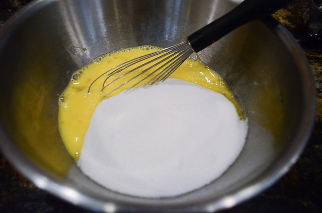 Egg and sugar being whisked together in a bowl.