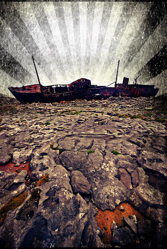 Rusted hulk of a ship wrecked on the rocks of Inisheer, the smallest of the Aran Islands off the wild Atlantic coast of Ireland done up in the photo app Pixlromatic
