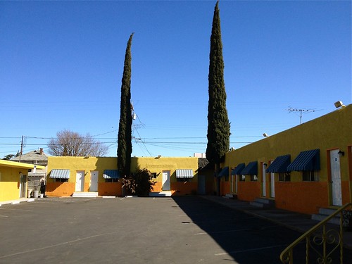street city travel blue trees shadow sky urban orange green colors landscape gold afternoon view bright empty parking scenic entrance lot motel traveller business doorway stop vacant rest roadside vacancy stockton awnings wishyouwerehere homeawayfromhome privatelife