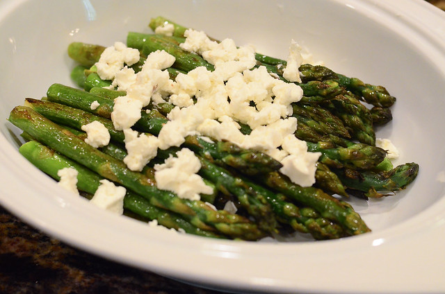 Goat cheese is added to the asparagus.