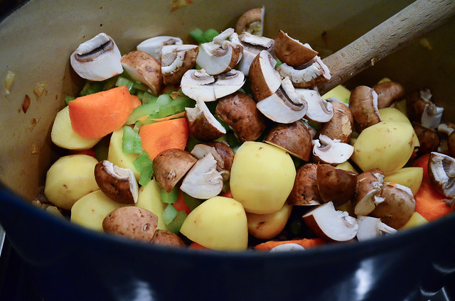 The chopped veggies are transferred to a pot.