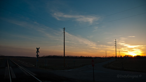 blue sunset sky orange silhouette sign clouds tracks utilitypole railroadcrossing