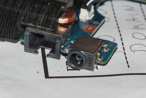 Cutting the defective power jack from the motherboard