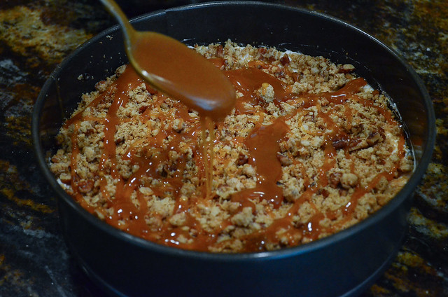 Caramel sauce is drizzled on top of the nut mixture.